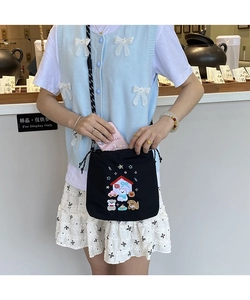 Detail of black canvas drawstring bucket bag with colorful cartoon embroidery and woven strap