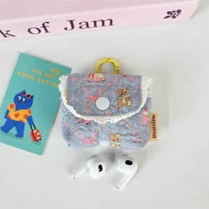 Detail of light blue floral bear print earphone case with white lace and yellow hook