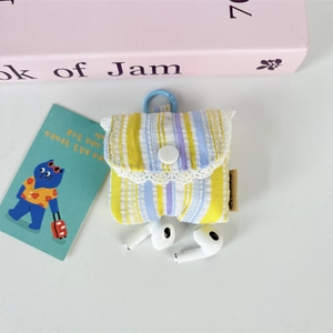 Detail of canvas earphone pouch with blue stripes, lace trim, and convenient hanging ring