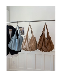 Detailed display of large suede tote bags in sky blue, beige and brown colors