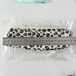 Leopard print corduroy pencil case measuring 21.5cm with top zipper and pull tab