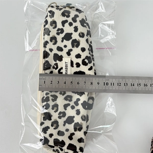 Detailed close-up of leopard print corduroy pencil case with RABBIT woven label