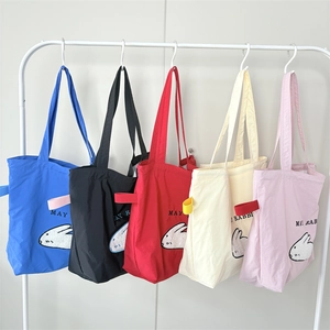 Detailed view of canvas tote bags featuring cute rabbit embroidery in five bright colors