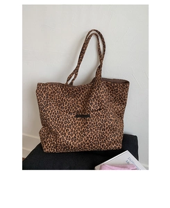 Detail shot of large leopard print tote bag with woven label on canvas fabric