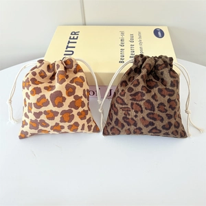 Set of two leopard print corduroy drawstring bags in light and dark brown tones