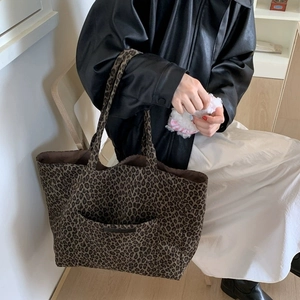 Large leopard print tote bag with outer pocket shown as a stylish shoulder bag