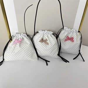 Polka dot drawstring storage bags with cute colored bows and black pull cords
