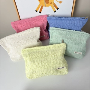 Pastel pleated cosmetic bags in pink, blue, white, green, and yellow with metal zipper