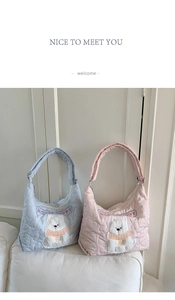 Detail of heart quilted tote bags with Lucky Puppy embroidery in blue and pink
