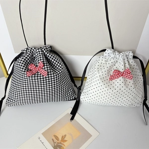 Polka dot and houndstooth drawstring jewelry pouches with red checkered bow accents