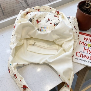 Cartoon embossed white canvas tote bag with waffle texture and interior zipper pocket