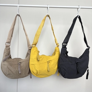 Minimalist nylon dumpling bag in beige yellow and black with adjustable straps