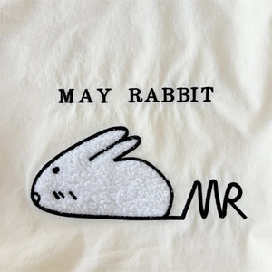 Detail of cute rabbit towel embroidery and MAY RABBIT lettering on beige canvas tote