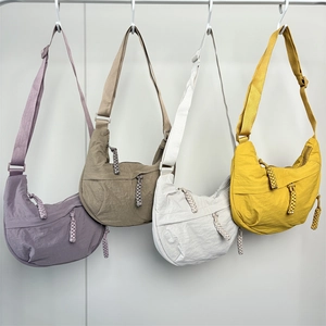 Minimalist nylon crescent crossbody bags in lavender, khaki, off-white, and yellow colors