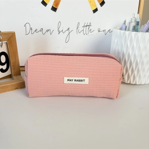 Detailed view of pink waffle texture fabric and May Rabbit label on a pencil case