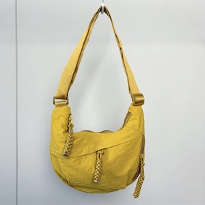Close-up of vibrant yellow nylon dumpling bag featuring durable zippers and woven pullers