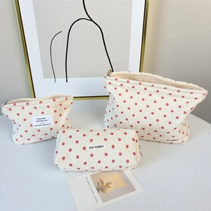 Detailed set of three floral makeup bags with bubble texture and flower patterns