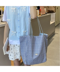 Blue and white checkered canvas tote bag featuring handmade label detail on shoulder