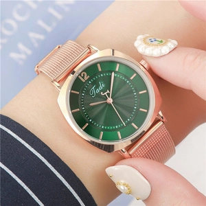 Women's rose gold mesh strap watch featuring a deep green sunburst dial and quartz movement