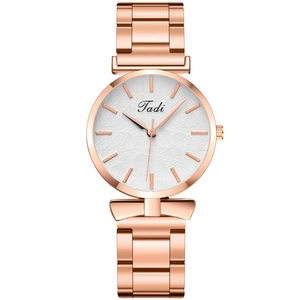 Women's rose gold quartz watch with a textured leaf pattern dial and metal strap