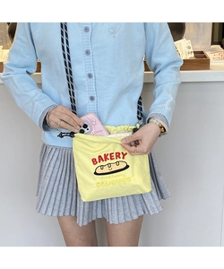 Detail of yellow canvas bag showing large capacity for phone and interior storage space