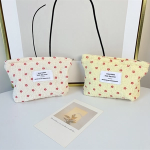 Detail of floral makeup bags in cream and yellow with textured bubble cotton fabric
