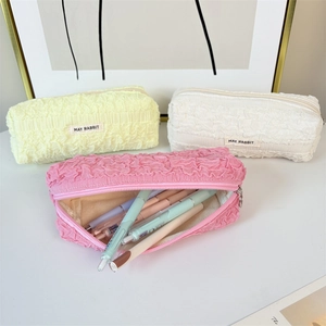 Detail of colorful bubble pleat pencil cases showing spacious capacity and soft texture