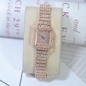 Detail of rose gold square watch with full diamond setting on a C-ring stand