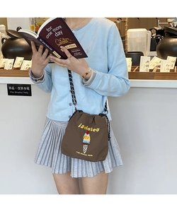 Detail of nylon bucket bag with ice cream embroidery and black-white checkered strap