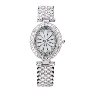 Elegant silver luxury watch for women featuring a crystal-set band and floral rhinestone dial