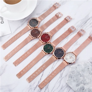 Multiple women's mesh band quartz watches with rose gold cases and multi-colored dials
