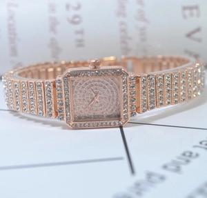 Close-up of luxury square quartz watch with full crystal rhinestones and rose gold band