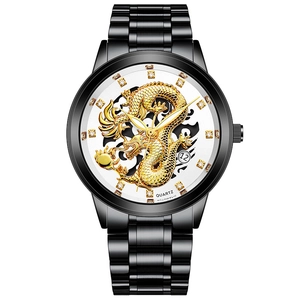 Detailed view of golden 3D dragon relief on black stainless steel dial with crystal markers