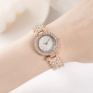 Luxurious rose gold women's watch with shimmering crystals on bezel and bracelet band