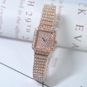 Detailed macro shot of a rose gold square watch with full crystal encrusted band and face