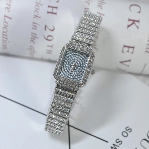 Close-up of luxury square women's quartz watch with full crystal pavé on silver steel band