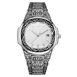 Detailed macro view of the intricate vintage scroll engraving on silver steel watch band