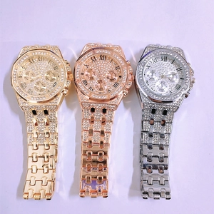 Close-up of three crystal-encrusted octagonal quartz watches in gold, rose gold and silver