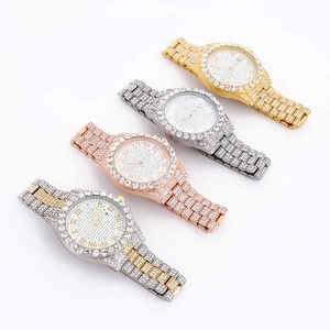 Row of iced out watches in gold, silver, and rose gold with crystal roman dial