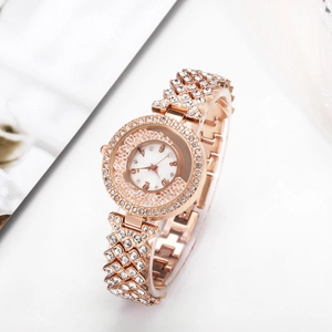 Rose gold women's watch with rhinestone bezel and flowing crystal dial accents