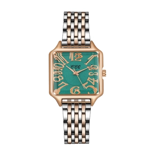 Detail view of the green sunray dial and gold Arabic numerals on square watch