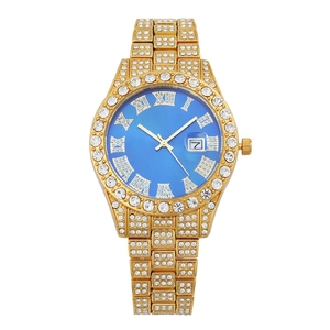 Detail of gold crystal watch featuring a royal blue dial and Roman numeral calendar