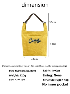 Detail view of yellow nylon tote with Candy print showing 43x41cm dimensions and 38cm handle