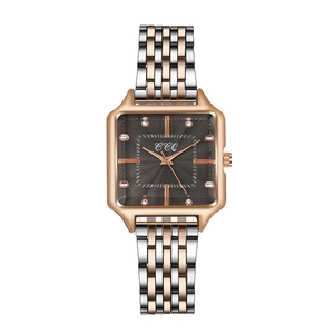Detailed view of square rose gold watch dial with sunray texture and rhinestone markers