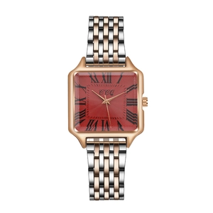 Close-up of red square dial watch with Roman numerals and silver rose gold metal strap