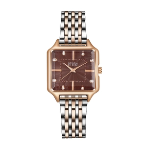 Detail of square watch dial with brown wave texture and rose gold diamond markers