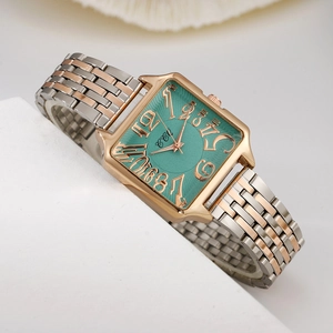 Detail of square green dial watch with two-tone rose gold and silver metal link strap
