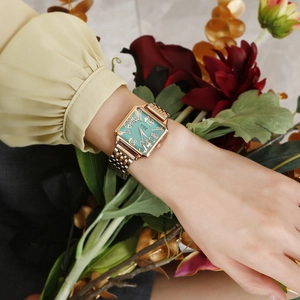 Detail of square quartz watch with vintage green dial and rose gold metal mesh strap