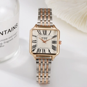 Detailed macro view of square rose gold watch face with roman numerals and bicolor steel band