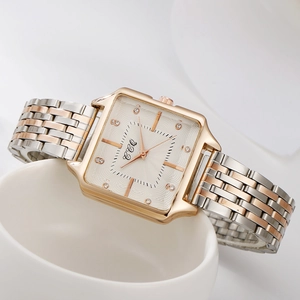 Detail of rose gold square watch with crystal markers on wave textured dial